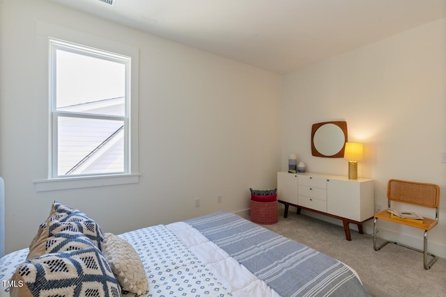 carpeted bedroom with multiple windows