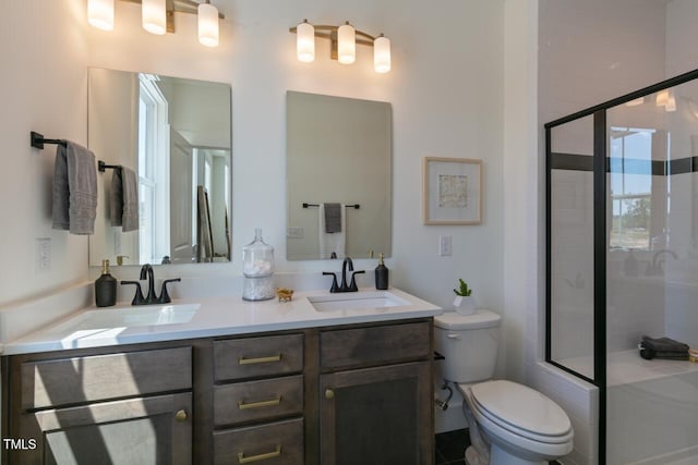 bathroom with vanity, toilet, and walk in shower