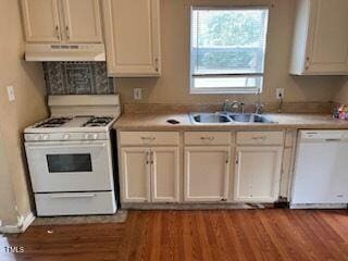 kitchen with white cabinets, sink, wood-type flooring, and white appliances