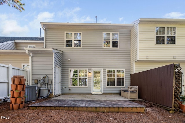 back of property with a wooden deck, fence, and central AC unit
