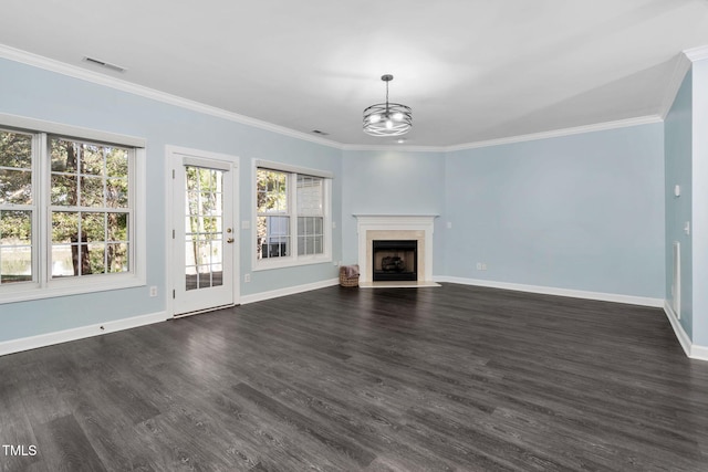 unfurnished living room featuring an inviting chandelier, dark hardwood / wood-style floors, and crown molding