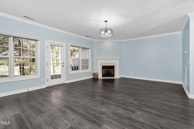 unfurnished living room with baseboards, a chandelier, dark wood-style flooring, ornamental molding, and a premium fireplace