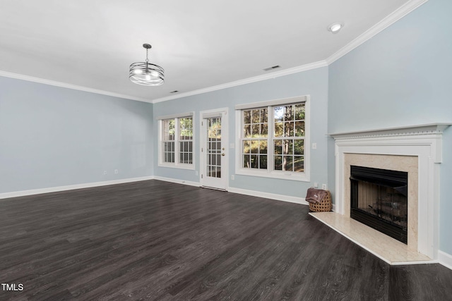 unfurnished living room featuring dark wood-type flooring, baseboards, ornamental molding, a premium fireplace, and a chandelier