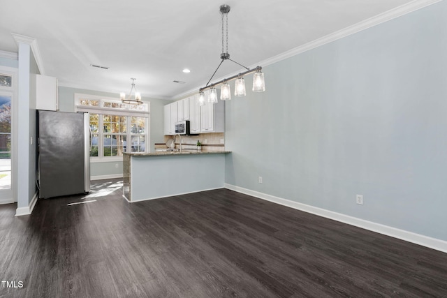 kitchen featuring stainless steel appliances, baseboards, white cabinets, dark wood-style flooring, and a chandelier
