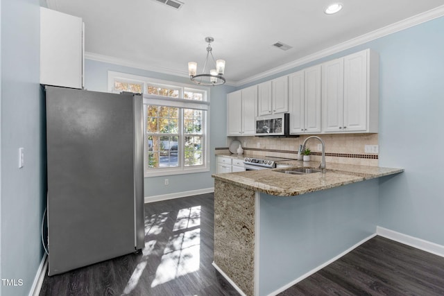 kitchen with stainless steel appliances, crown molding, white cabinets, dark wood finished floors, and light stone counters