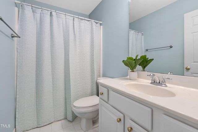 bathroom featuring vanity, tile patterned flooring, and toilet