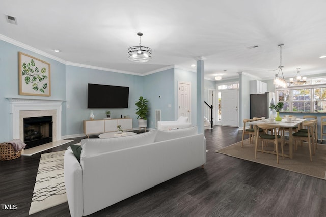 living room featuring dark hardwood / wood-style flooring and crown molding