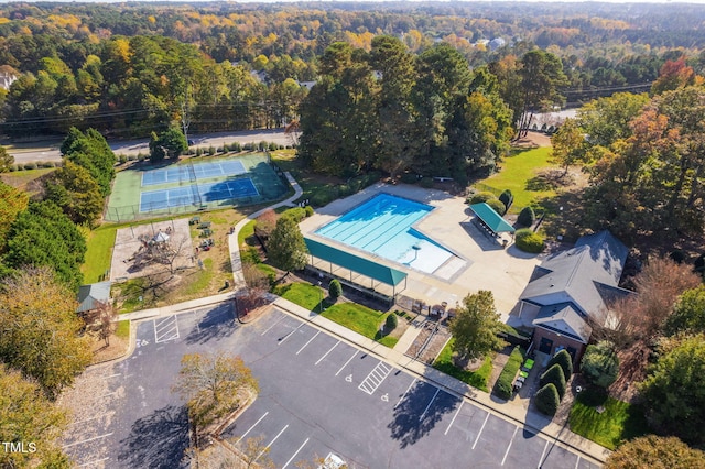 aerial view of a heavily wooded area and a pool area