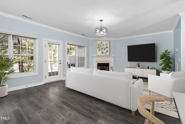 2106 White Pond Ct, Apex, NC 27523 - living room featuring crown molding, dark wood-style floors, baseboards, a fireplace, and a chandelier