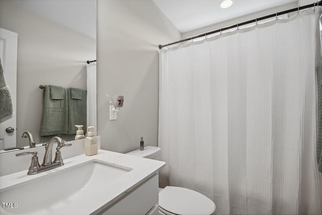 bathroom featuring vanity and toilet