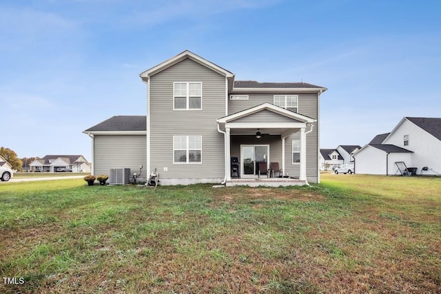 back of house with central AC unit, ceiling fan, a yard, and a patio