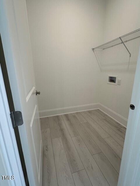 laundry area featuring washer hookup and light wood-type flooring