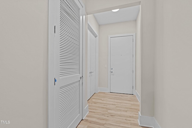 hallway with light hardwood / wood-style flooring