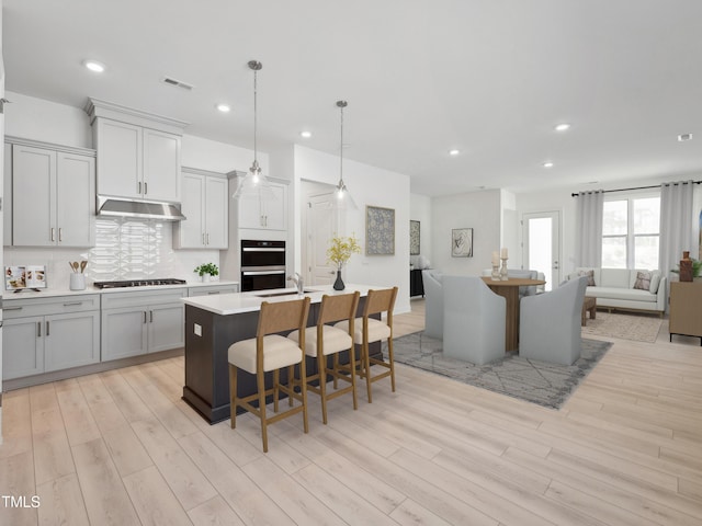 520 Gainer Dr # 6, Raleigh, NC 27610 - kitchen featuring black cooktop, open floor plan, light wood-style flooring, light countertops, and recessed lighting
