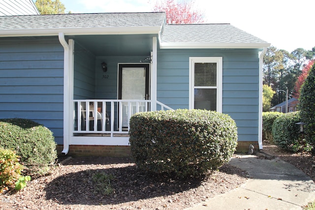 property entrance with covered porch