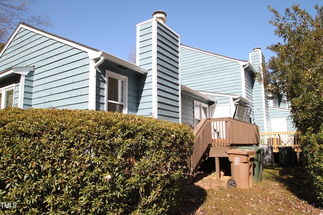 view of home's exterior with a wooden deck