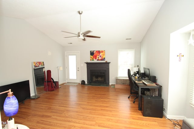 home office with vaulted ceiling, light hardwood / wood-style flooring, and ceiling fan