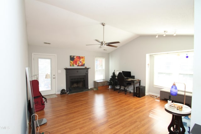 living room with lofted ceiling, light hardwood / wood-style floors, and ceiling fan