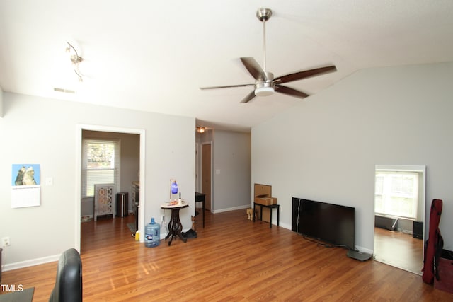 living room featuring lofted ceiling, wood-type flooring, and ceiling fan