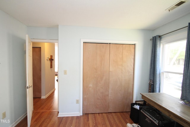 bedroom with a closet and hardwood / wood-style floors