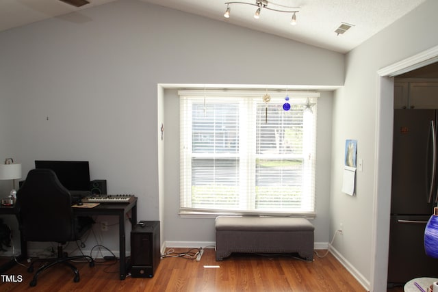 office area with hardwood / wood-style flooring and vaulted ceiling