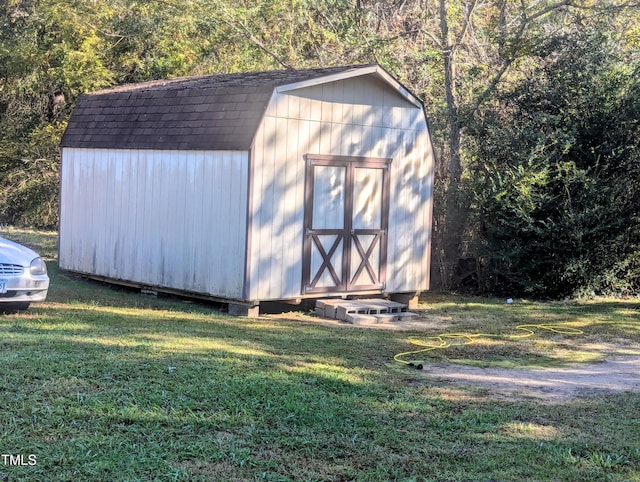 view of outbuilding featuring a yard