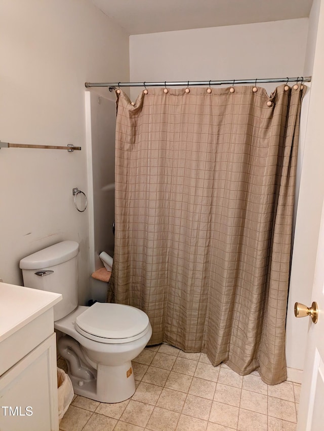 bathroom featuring vanity, a shower with curtain, toilet, and tile patterned floors