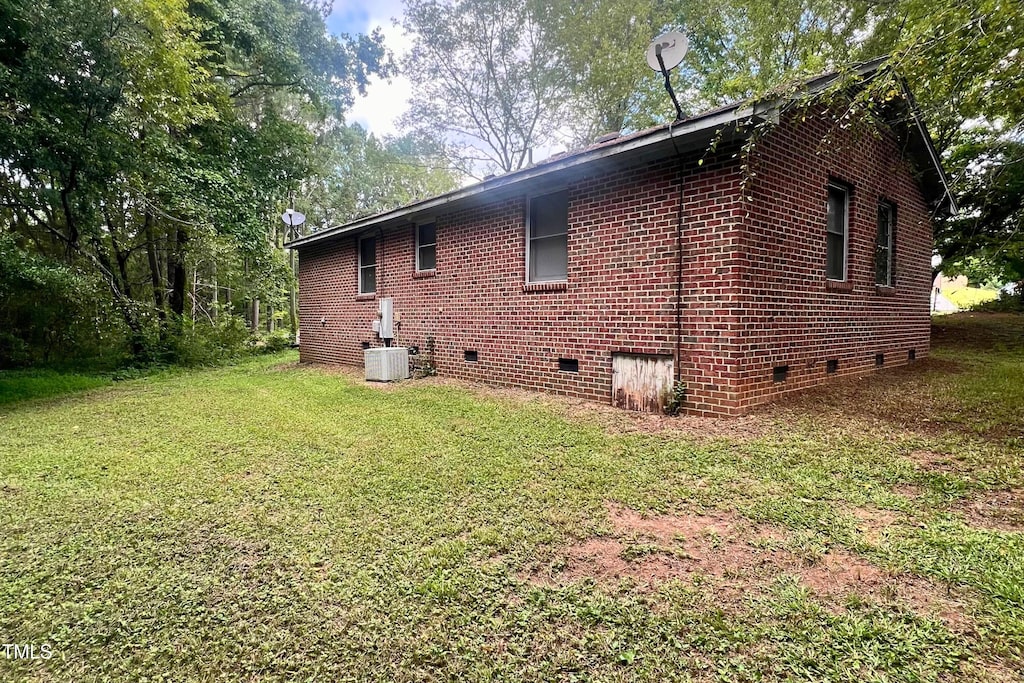 view of home's exterior featuring central AC and a lawn