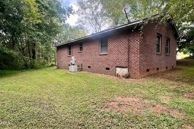 view of home's exterior featuring central AC and a lawn