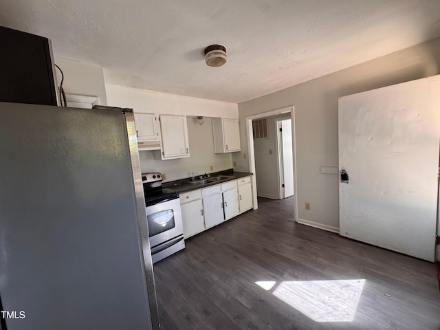 kitchen with white cabinets, appliances with stainless steel finishes, dark hardwood / wood-style floors, and sink