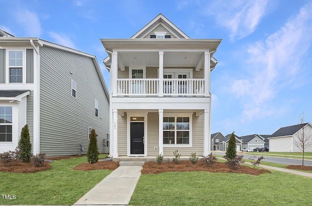 view of front of home with a front lawn and a balcony