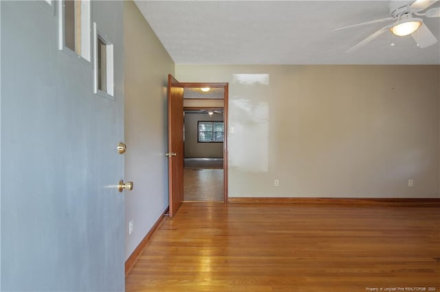 empty room featuring light hardwood / wood-style flooring and ceiling fan