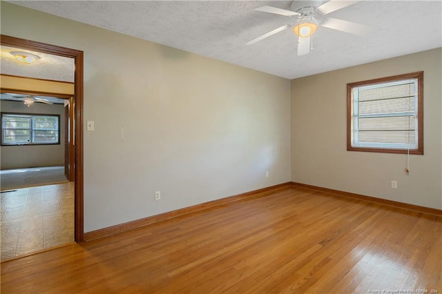 spare room with light hardwood / wood-style flooring, a textured ceiling, and ceiling fan