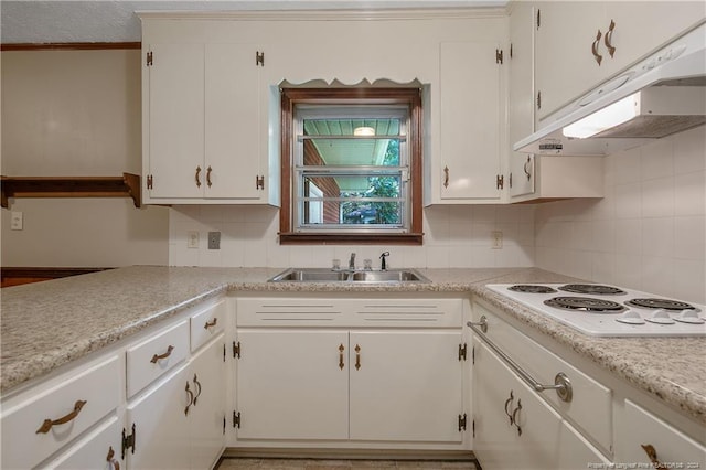 kitchen featuring white electric cooktop, sink, white cabinets, and decorative backsplash