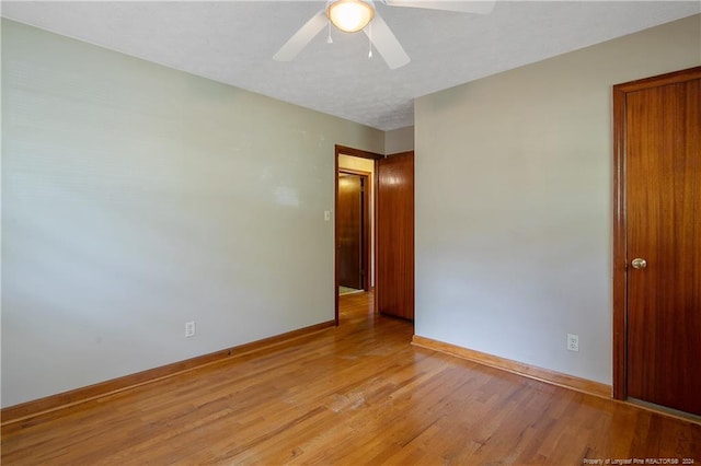 empty room featuring light hardwood / wood-style flooring and ceiling fan