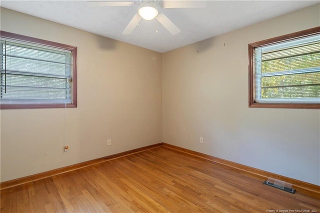 unfurnished room with ceiling fan and hardwood / wood-style floors