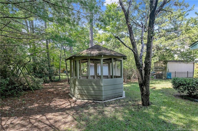 view of outdoor structure with a gazebo and a lawn