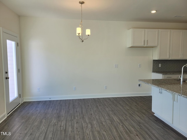 3612 Tarmac Rd Unit Ep 127, Wilson, NC 27896 - kitchen featuring white cabinets, light stone counters, dark wood-style floors, and recessed lighting