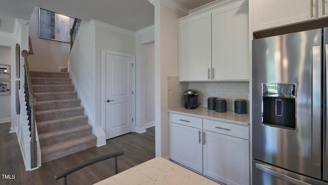 kitchen with white cabinets, tasteful backsplash, dark wood-type flooring, and stainless steel refrigerator with ice dispenser