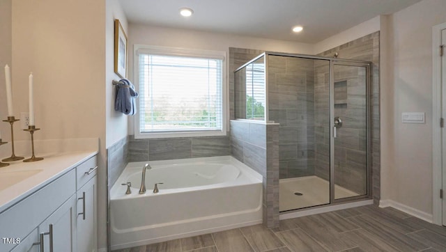 bathroom with vanity and independent shower and bath