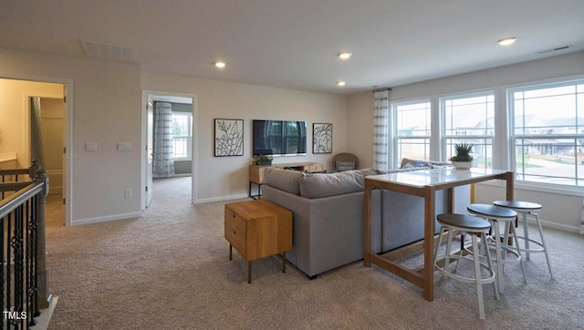 carpeted living room featuring plenty of natural light