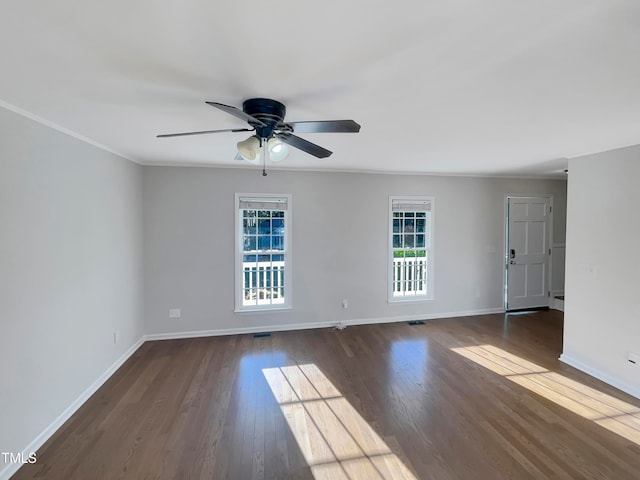 unfurnished room with ornamental molding, dark wood-type flooring, plenty of natural light, and ceiling fan