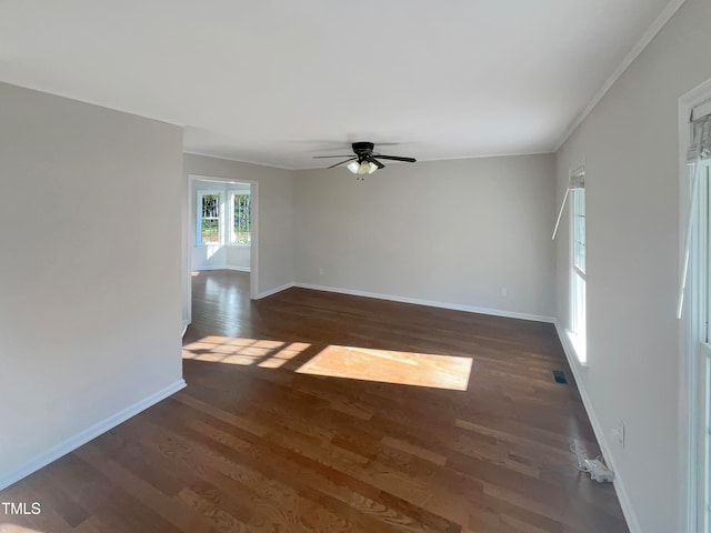 empty room with crown molding, dark hardwood / wood-style floors, and ceiling fan