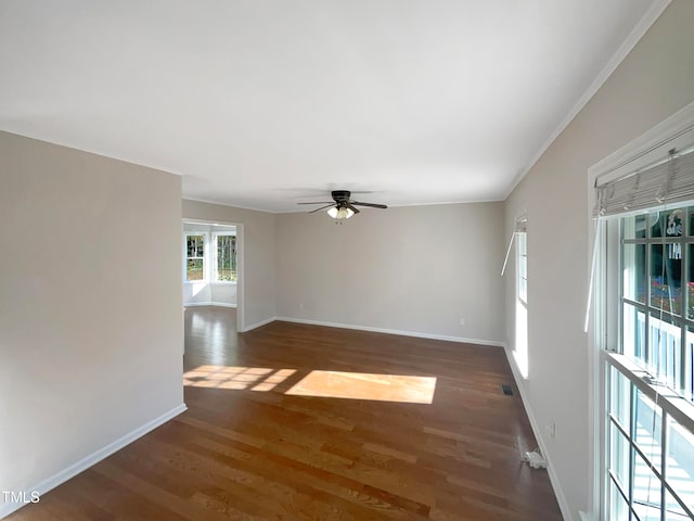 unfurnished room featuring crown molding, dark hardwood / wood-style floors, and ceiling fan