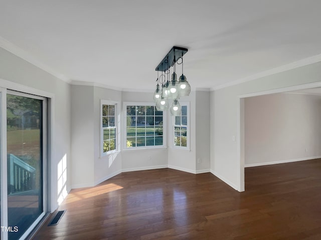 unfurnished dining area featuring crown molding, an inviting chandelier, and dark hardwood / wood-style floors