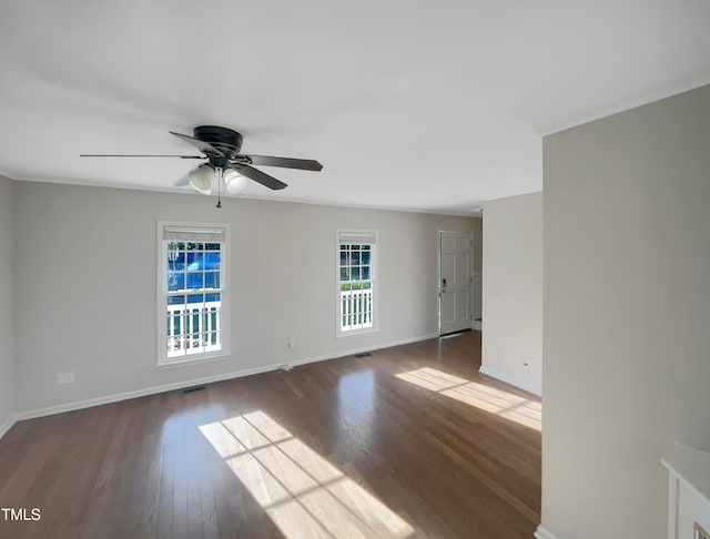 spare room with ceiling fan and dark hardwood / wood-style flooring