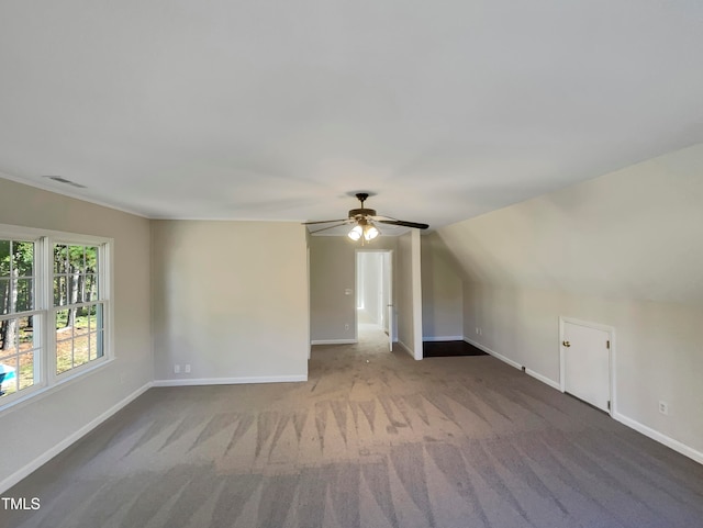 additional living space featuring lofted ceiling, carpet flooring, and ceiling fan