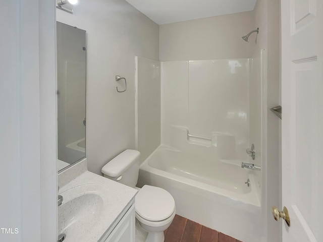 full bathroom featuring toilet, hardwood / wood-style flooring, vanity, and tub / shower combination