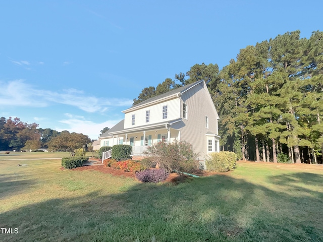 view of front of house with covered porch and a front lawn