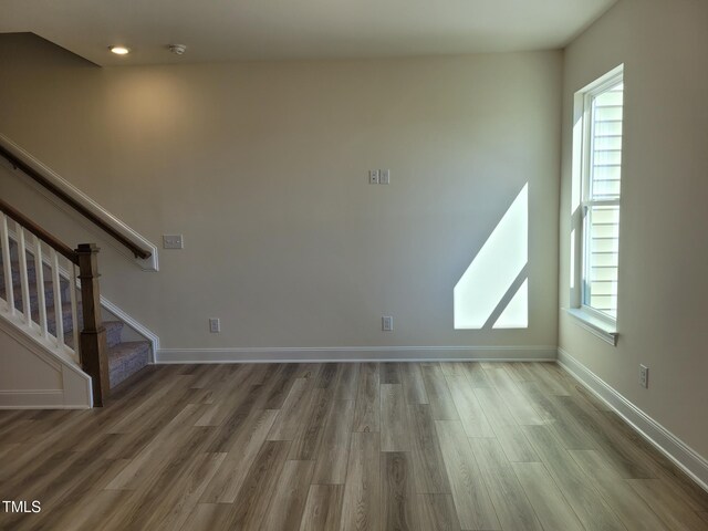 3614 Tarmac Rd Unit Ep 128, Wilson, NC 27896 - unfurnished living room with wood finished floors, stairs, and baseboards